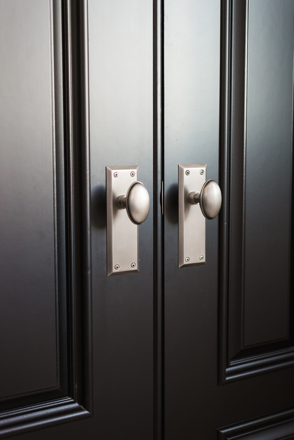 Vintage pewter door knobs on black interior door. Great sources in this blog post for antique style door knobs!