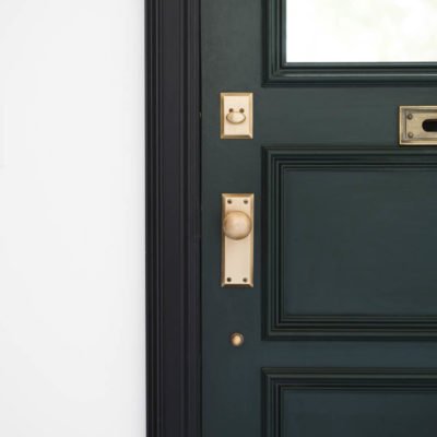 Dark green door with black casing and vintage brass hardware. Great Sources for hardware!!