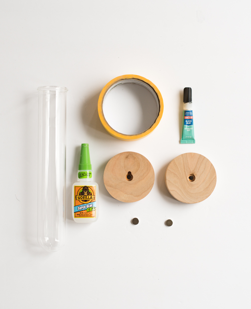 Test tube, super glue, disc, painters tape, glass glue, magents