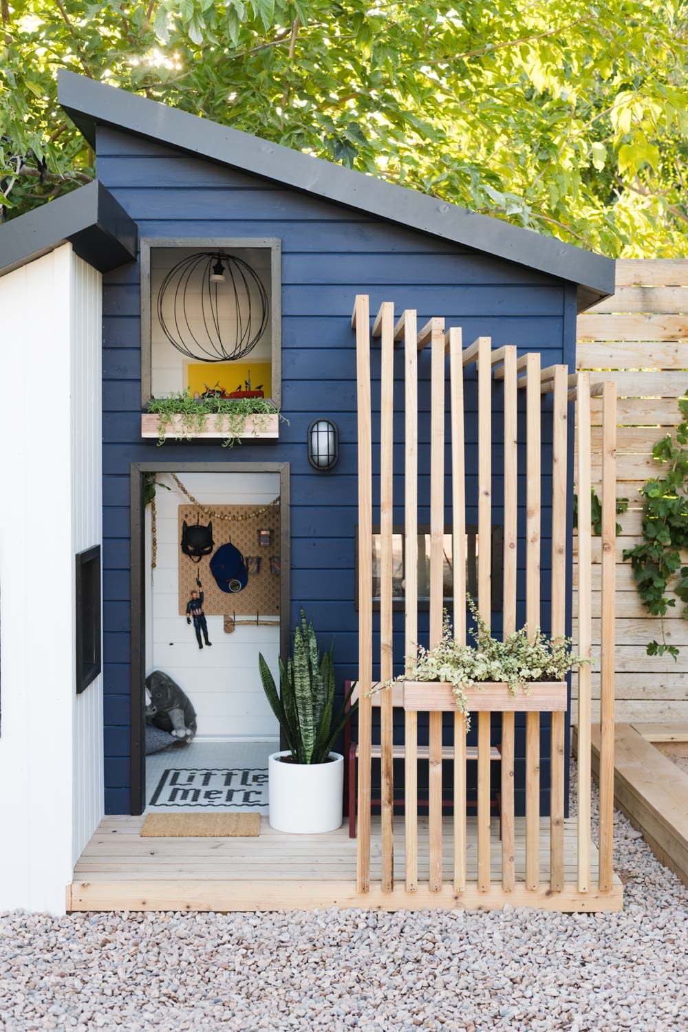 Magnificent backyard modern playhouse painted Sherwin Williams Naval. #paintcolors #sherwinwilliamsnaval #bluepaintcolor #navybluepaint